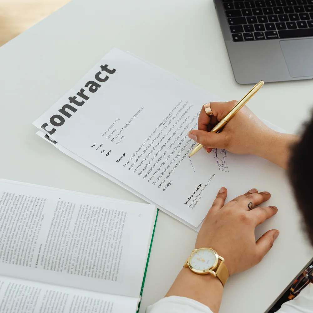 Close-up of investor signing a real estate contract during acquisition or disposition