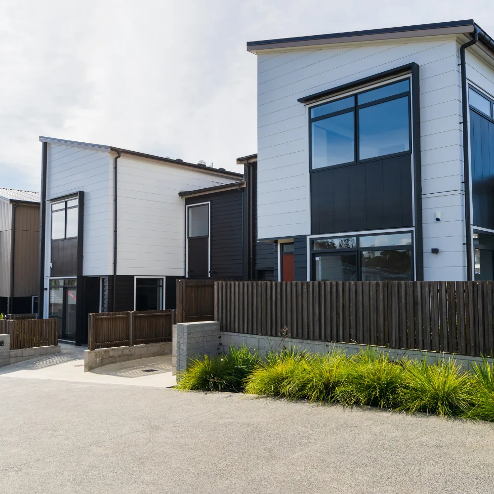 Modern residential townhouses with clean architecture and fenced yards