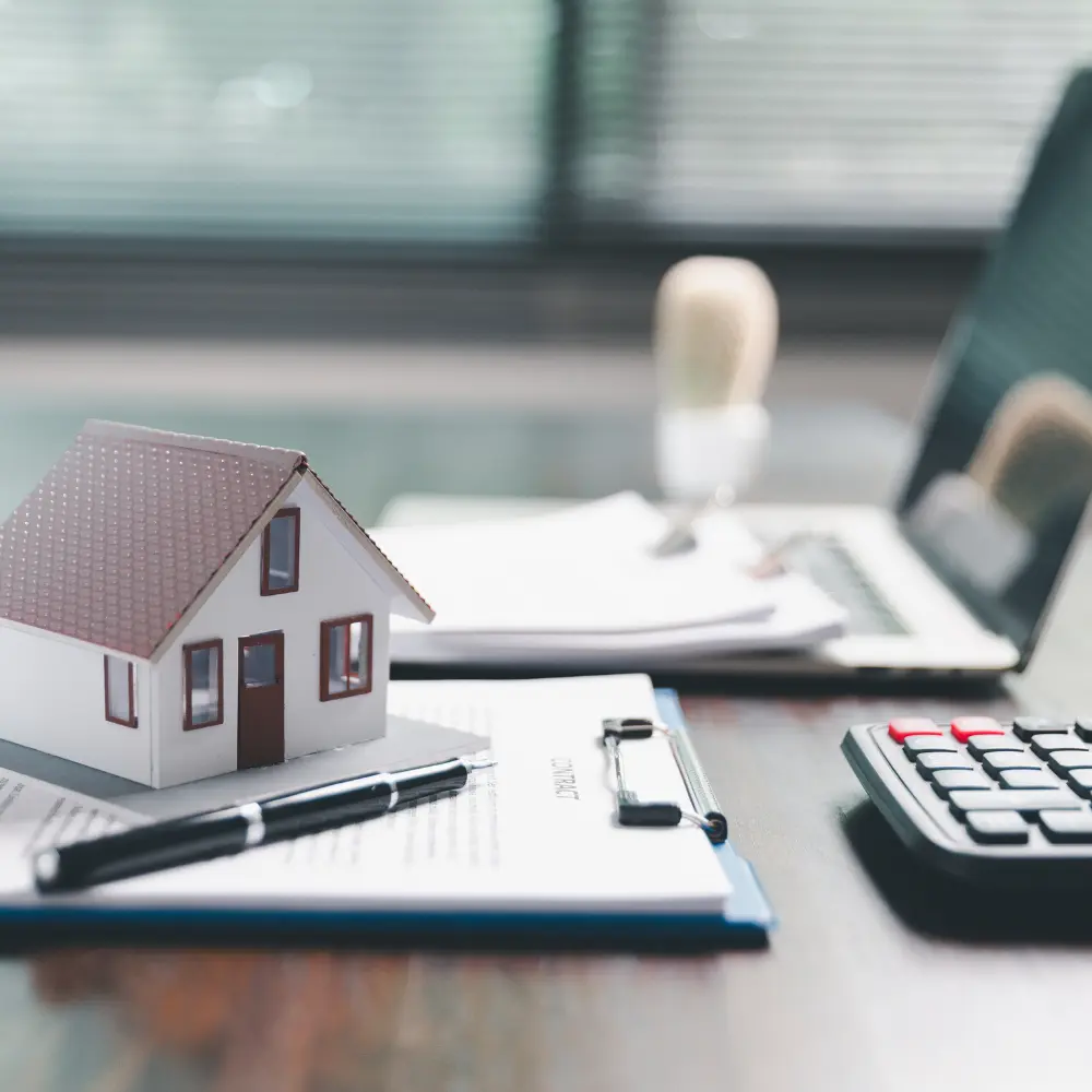 Real estate valuation and financial analysis documents with a model house and calculator